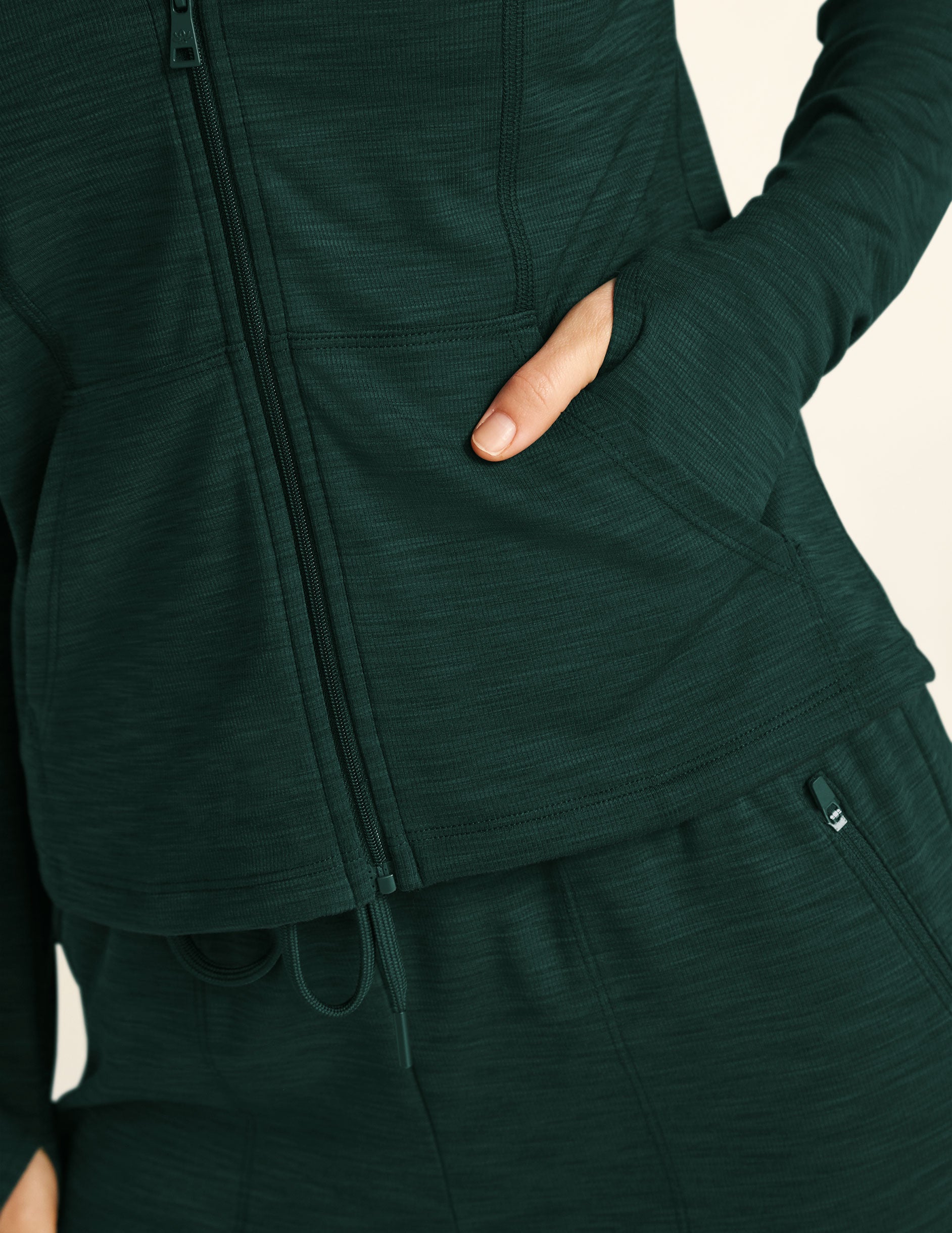 green zip-up hooded jacket. 