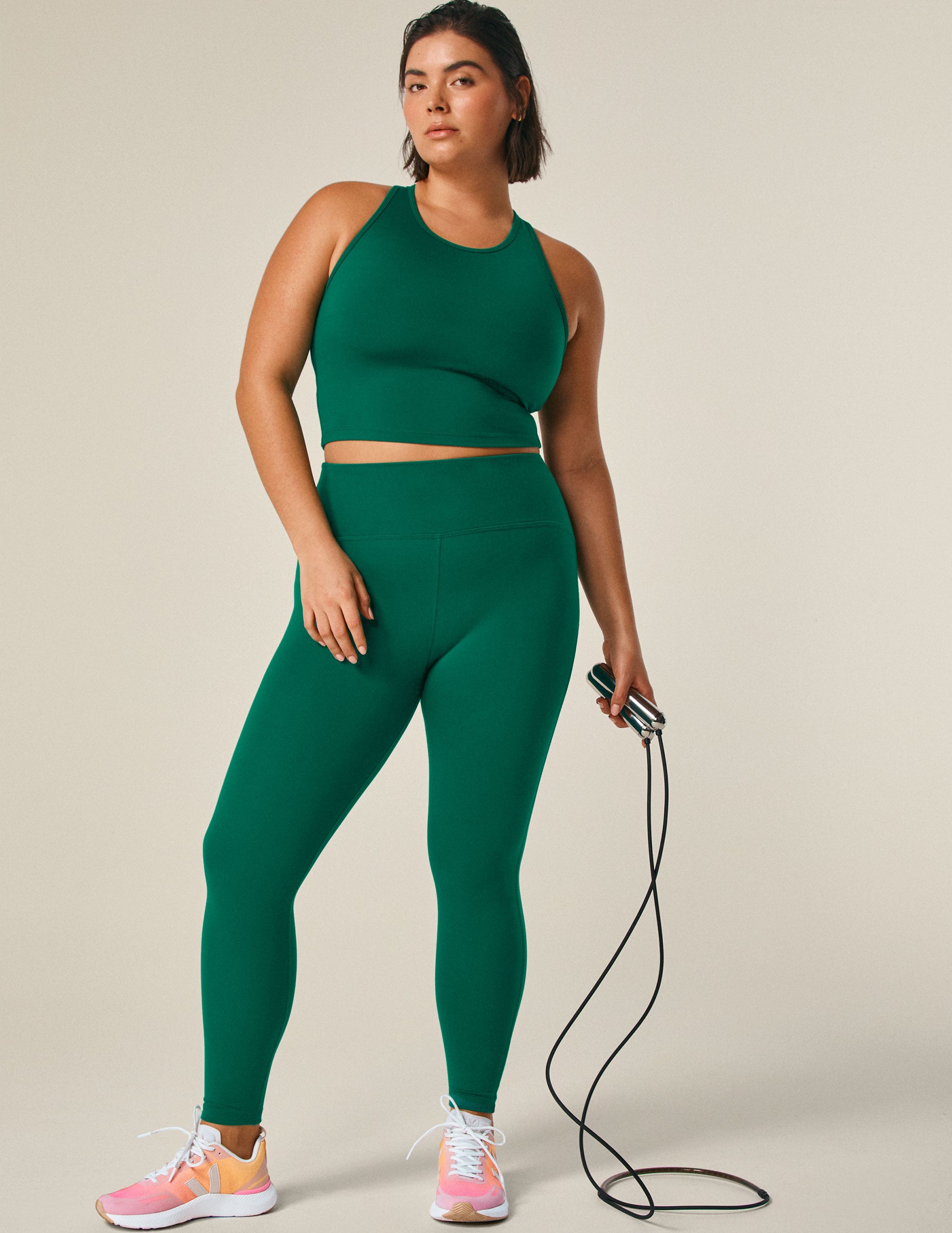 green scoop neck racerback cropped tank with an open back detail held with bartacks.