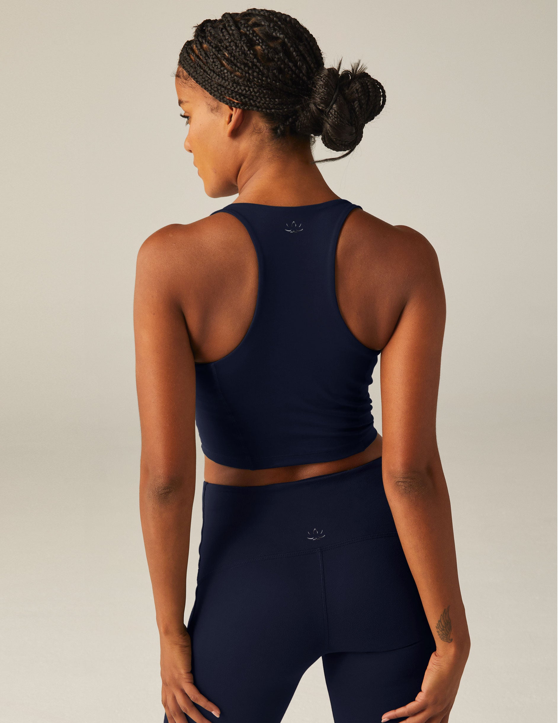 navy blue racerback cropped tank top with a built-in bra and princess seams. 