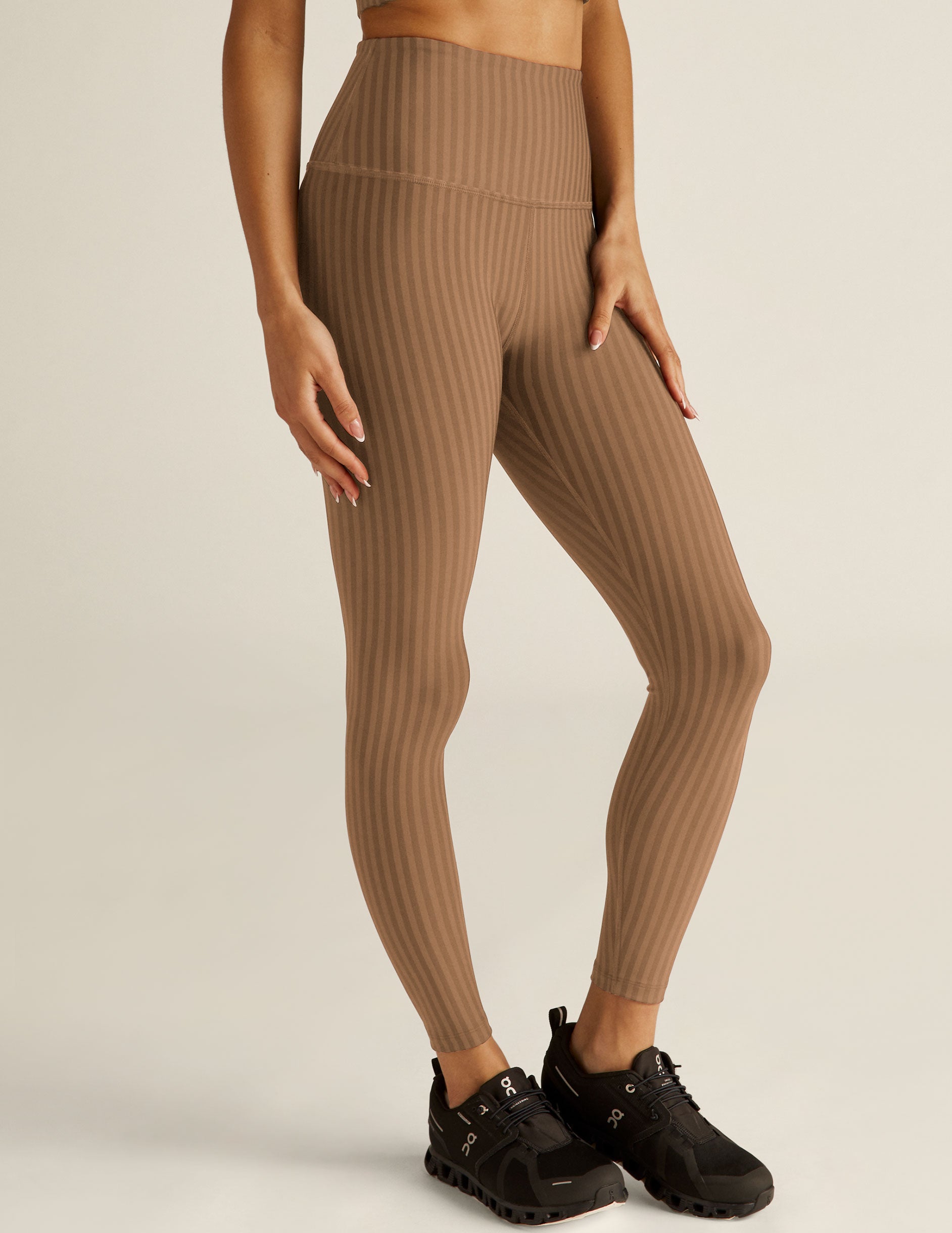 brown pin-striped printed high-waisted midi leggings.