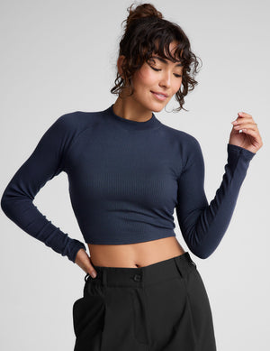 blue ribbed mock-neck cropped long sleeve top. 