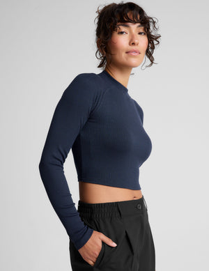 blue ribbed mock-neck cropped long sleeve top. 