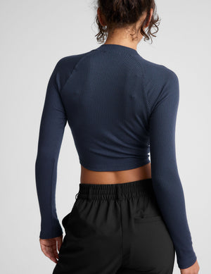 blue ribbed mock-neck cropped long sleeve top. 