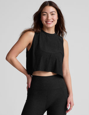 black relaxed fit and cropped tank top with a ribbed scooped neckline and ribbed arm holes. 