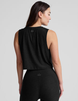 black relaxed fit and cropped tank top with a ribbed scooped neckline and ribbed arm holes. 
