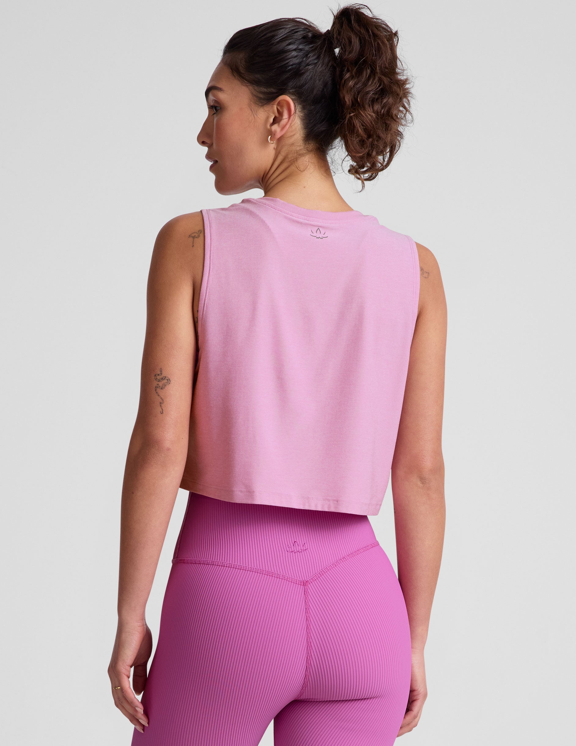 pink relaxed fit cropped tank with a scooped, ribbed neckline, and ribbed arm holes. 