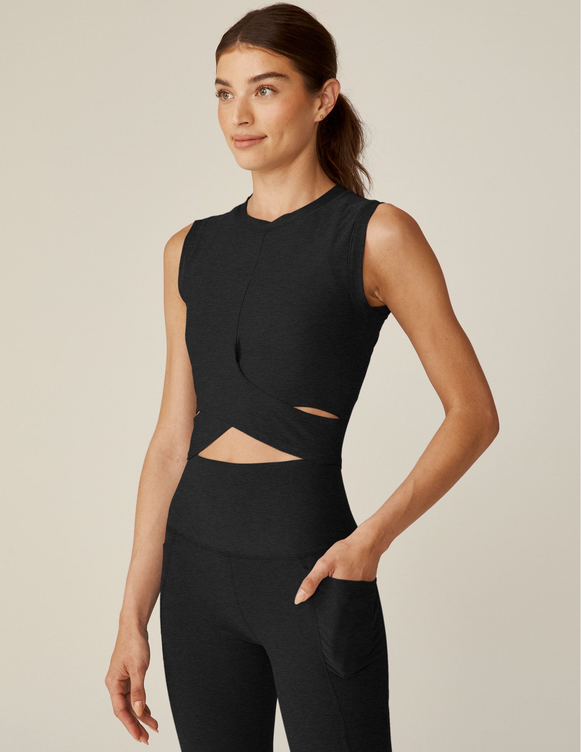 black wide strap cropped tank with a crossover cutout detailing in front.