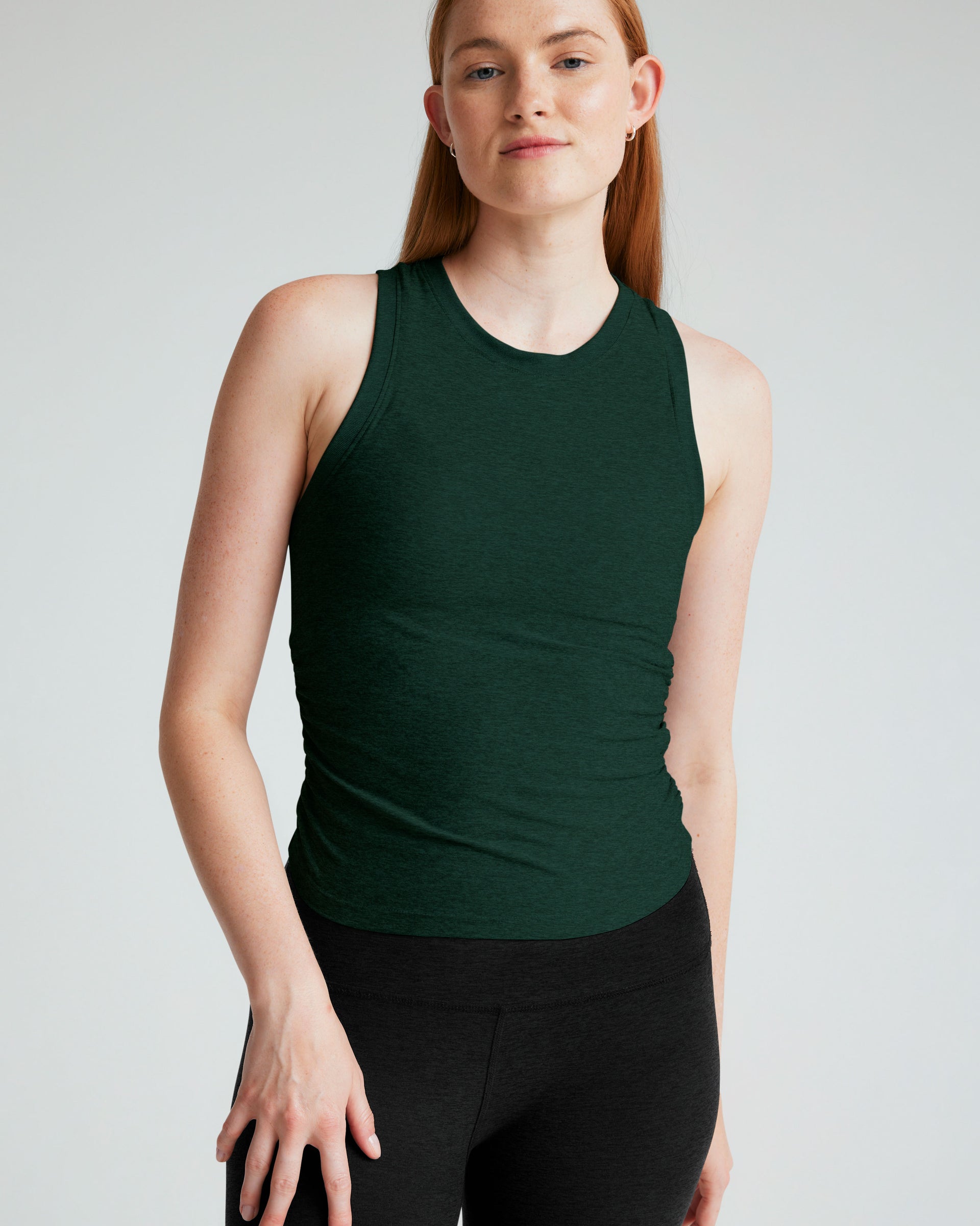 green tank top with ruching at sides.