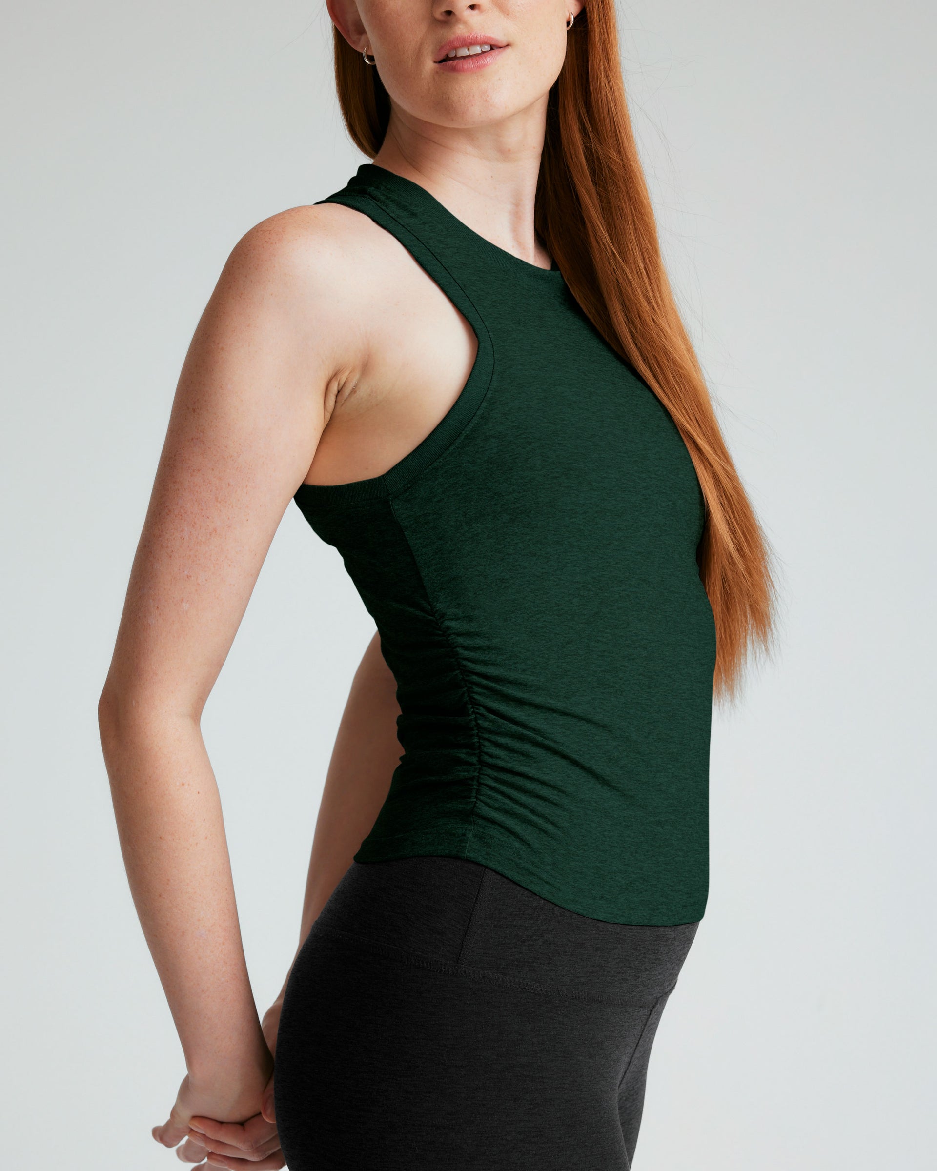 green tank top with ruching at sides.