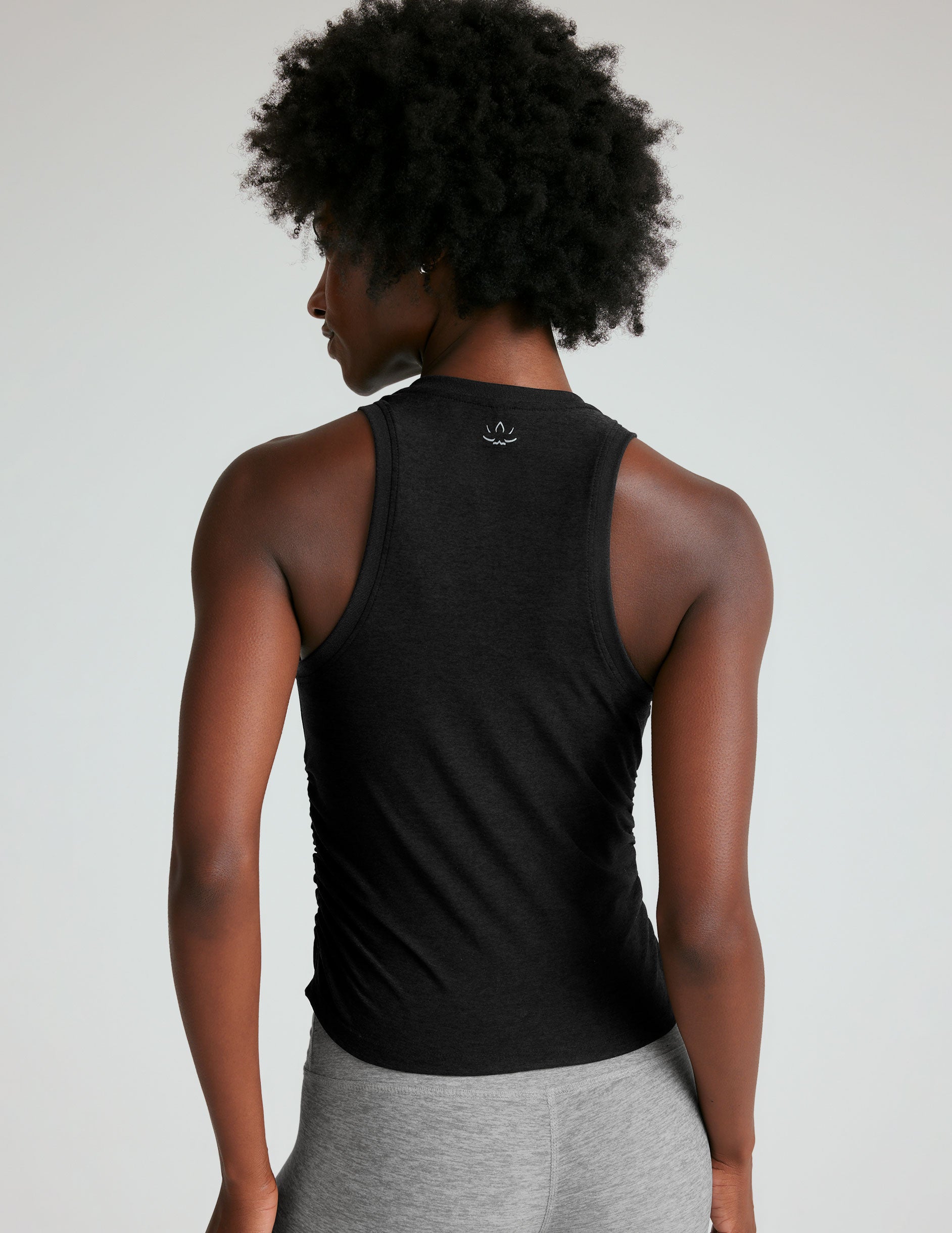 black scoop neck tank top with shirring details down the sides. 