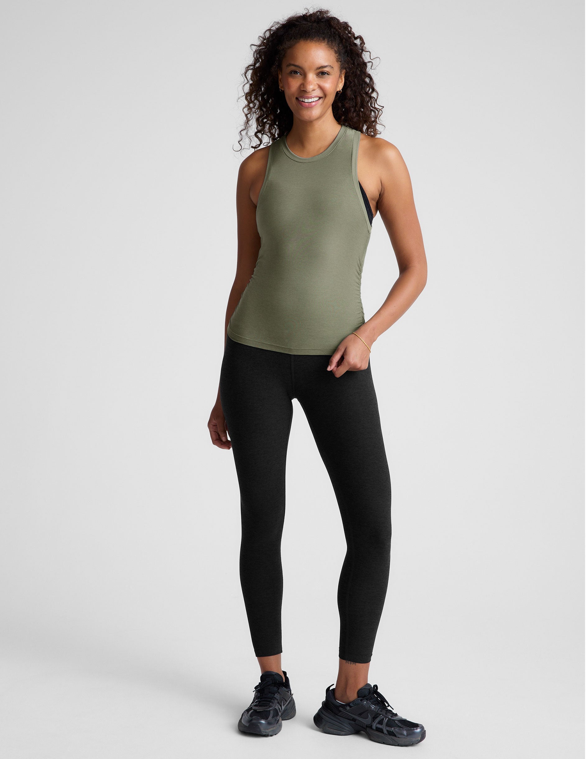 green scoop neck tank top with shirred detailing on the sides. 