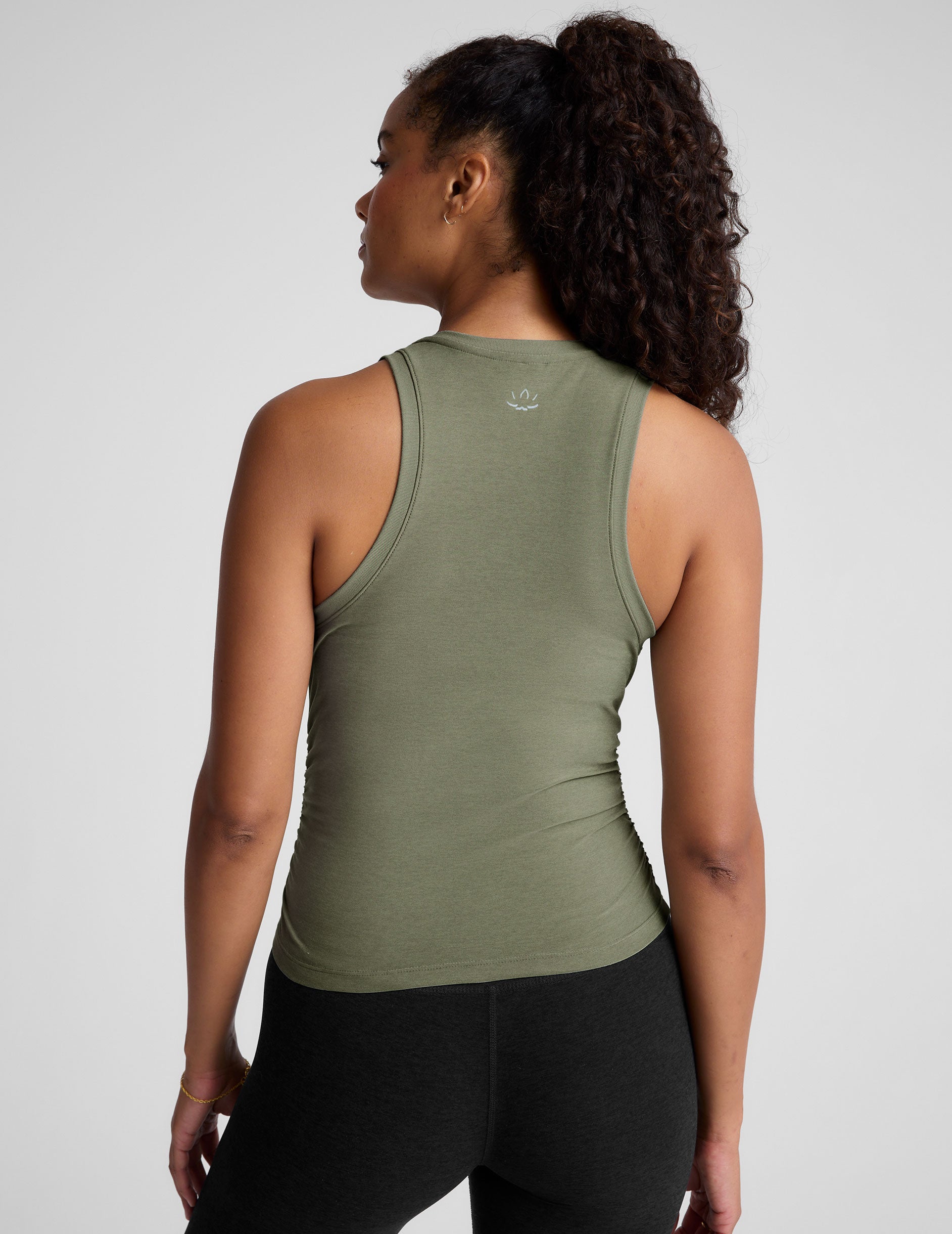 green scoop neck tank top with shirred detailing on the sides. 