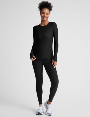 black crew neck long sleeve top with thumb holes. 