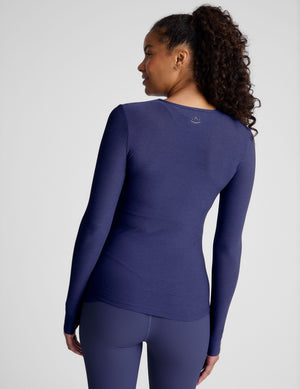 blue long sleeve top with a crew neckline. 
