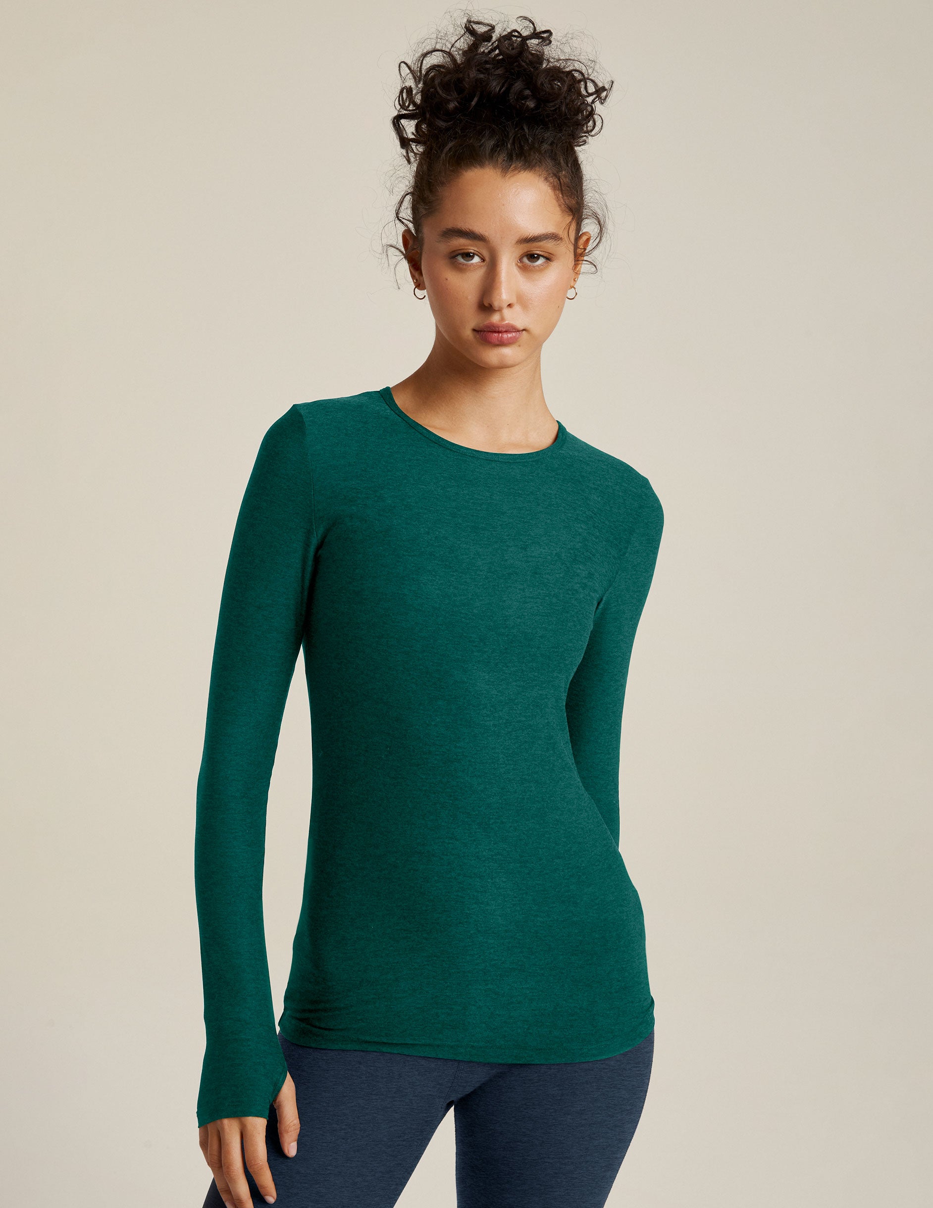 green long sleeve pullover top with thumb holes. 