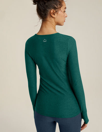green long sleeve pullover top with thumb holes.