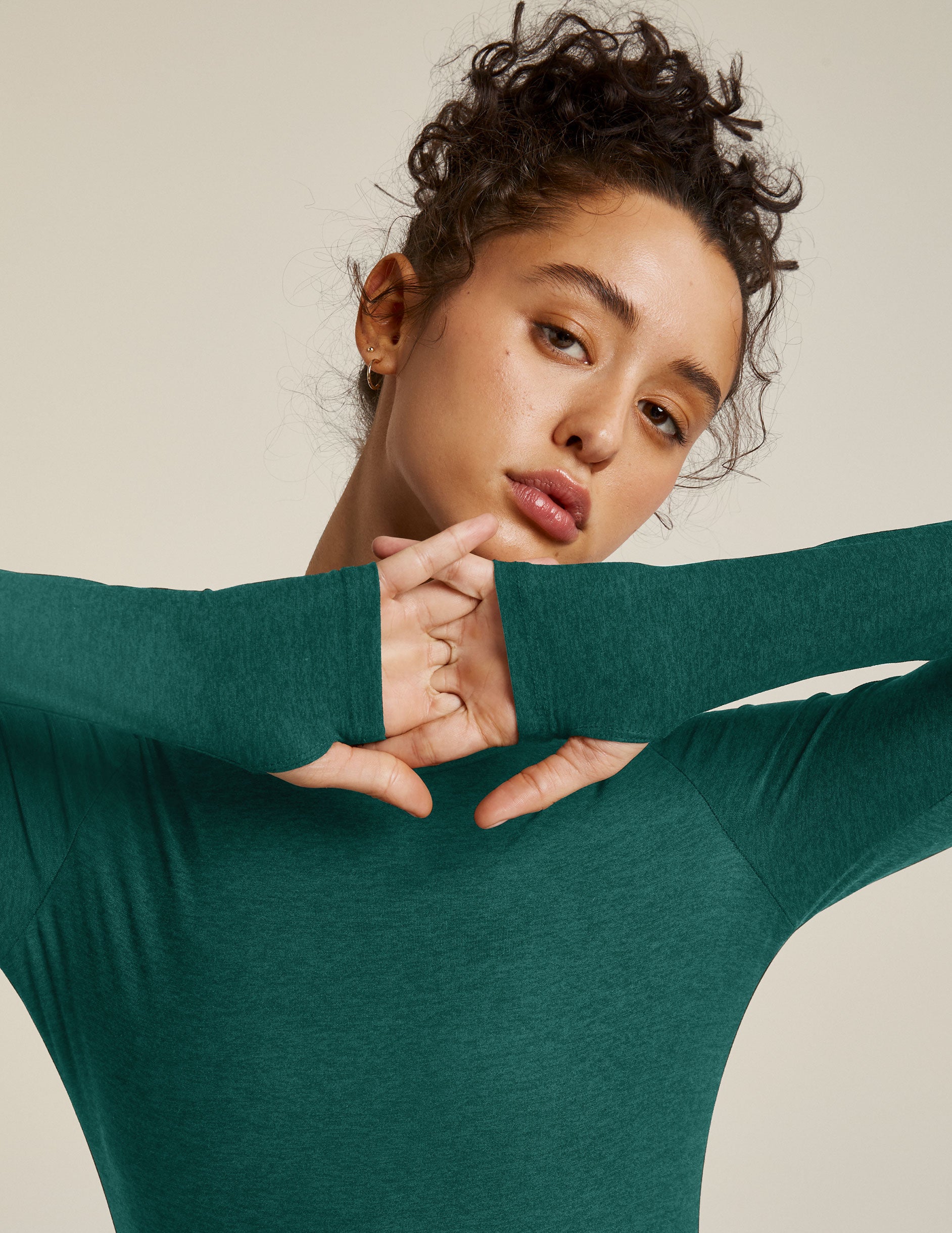 green long sleeve pullover top with thumb holes.