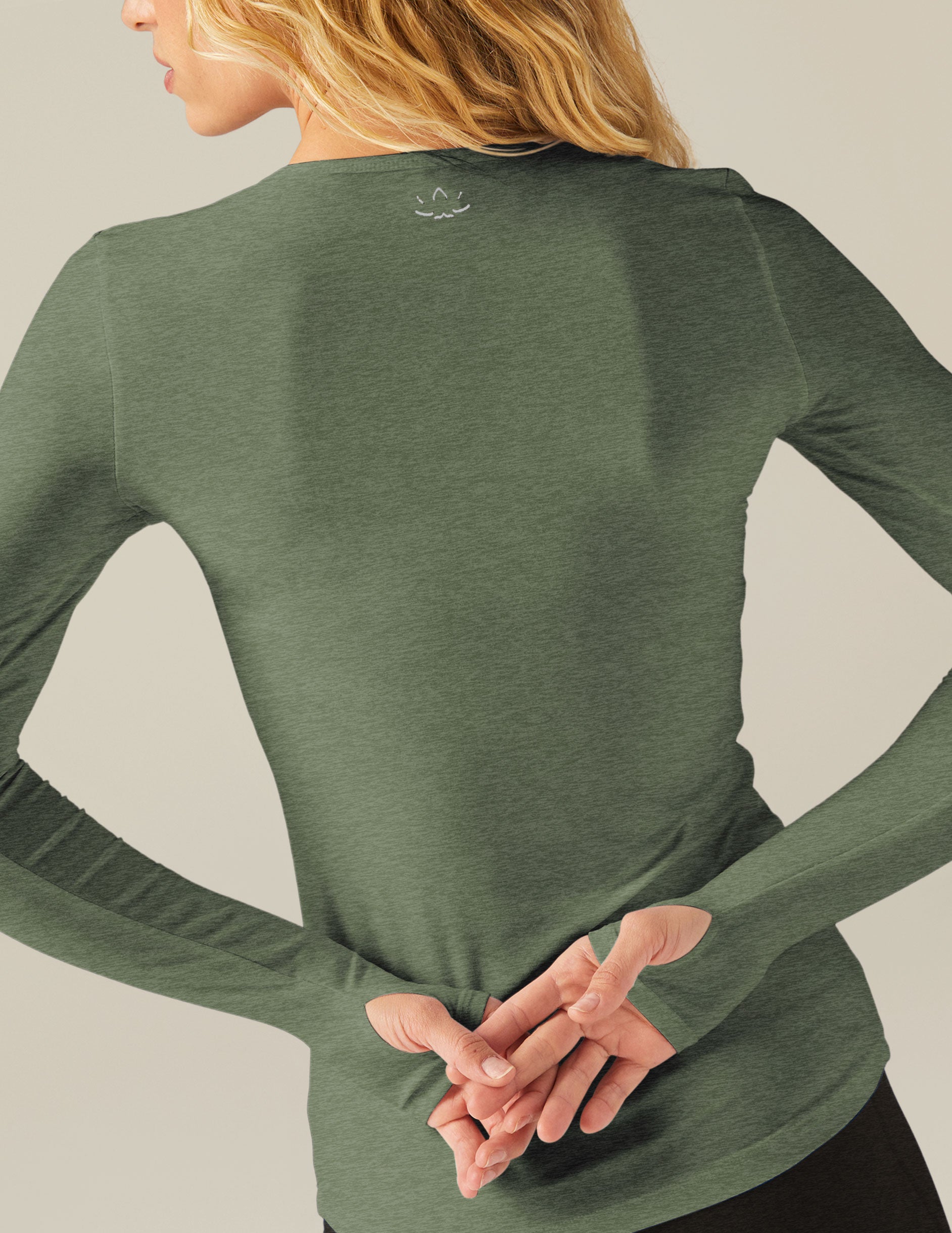 green long sleeve top with thumb holes.