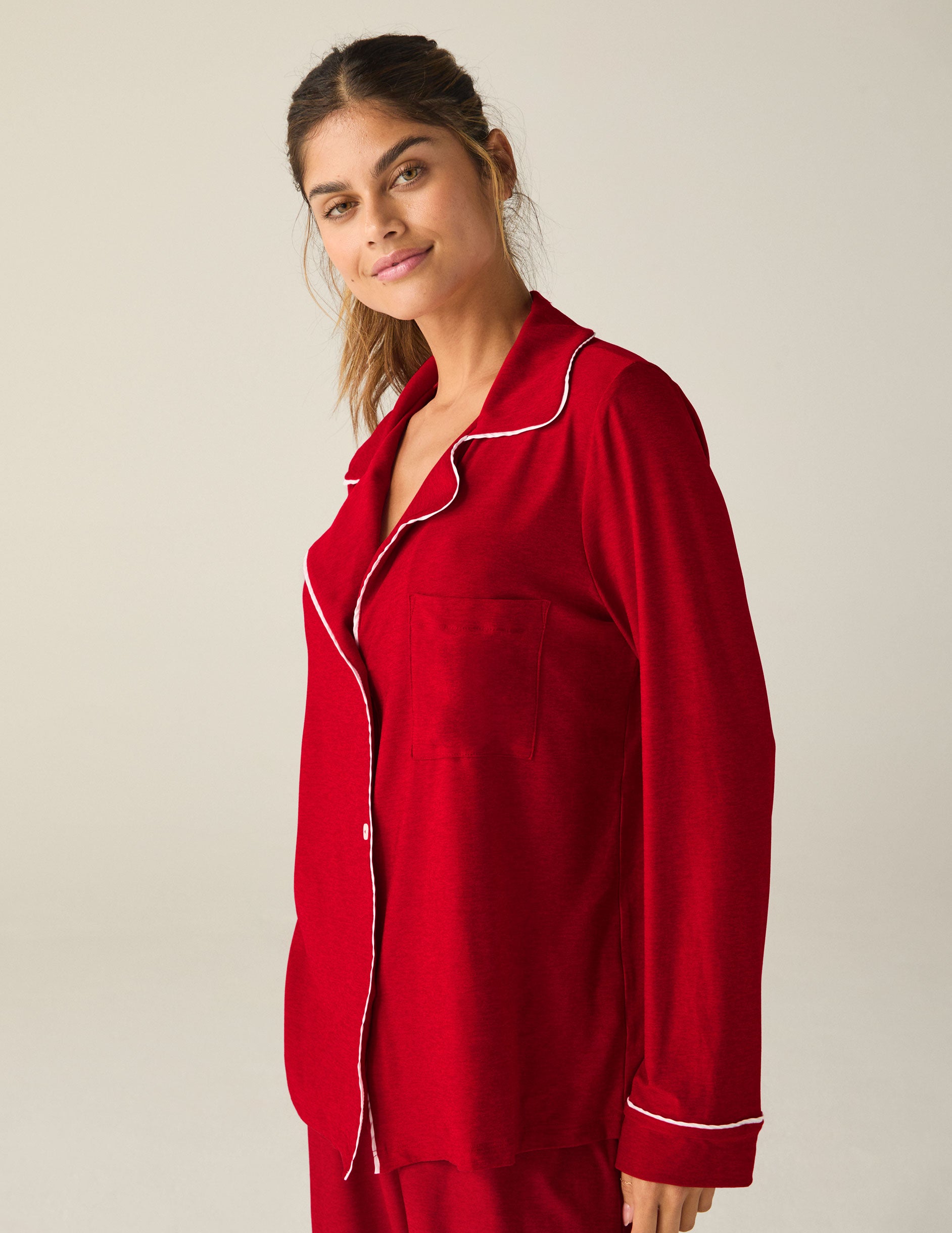 red button-up sleep shirt with white piping. 