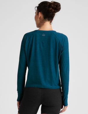 blue long sleeve crew neck top. 
