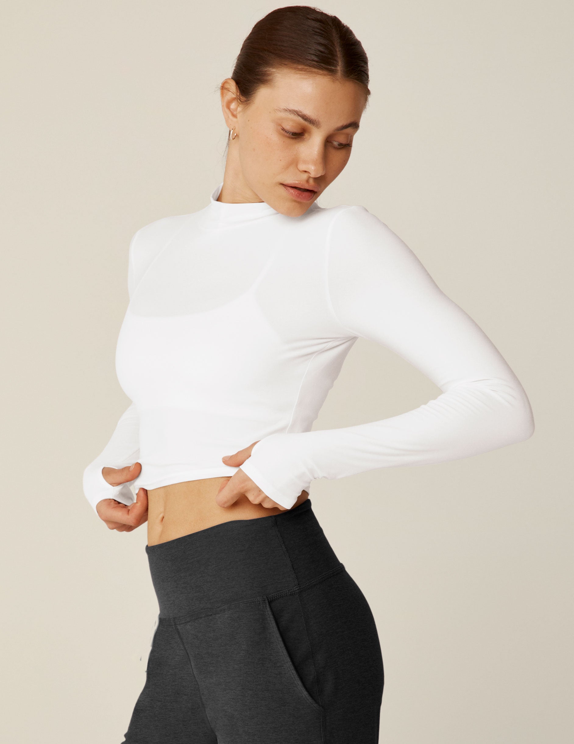 white cropped mock neck long sleeve with thumb holes. 