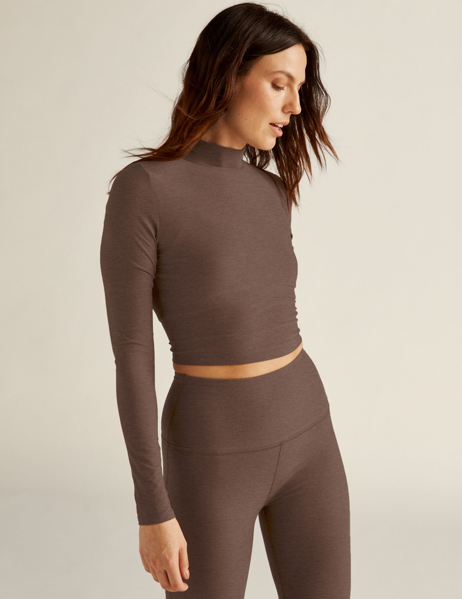 brown long sleeve mock neck cropped pullover with thumb holes. 