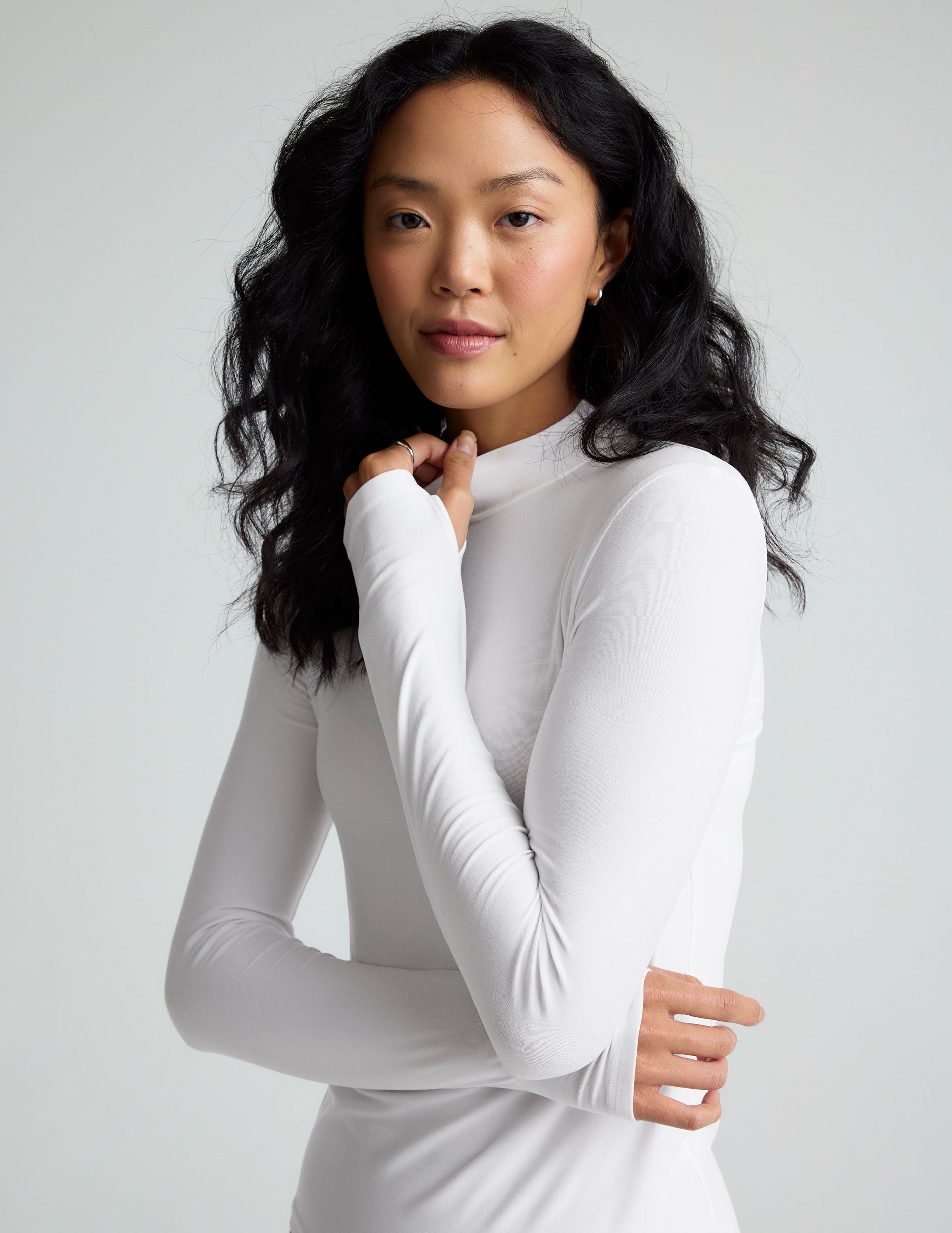 white mock neck long sleeve top.