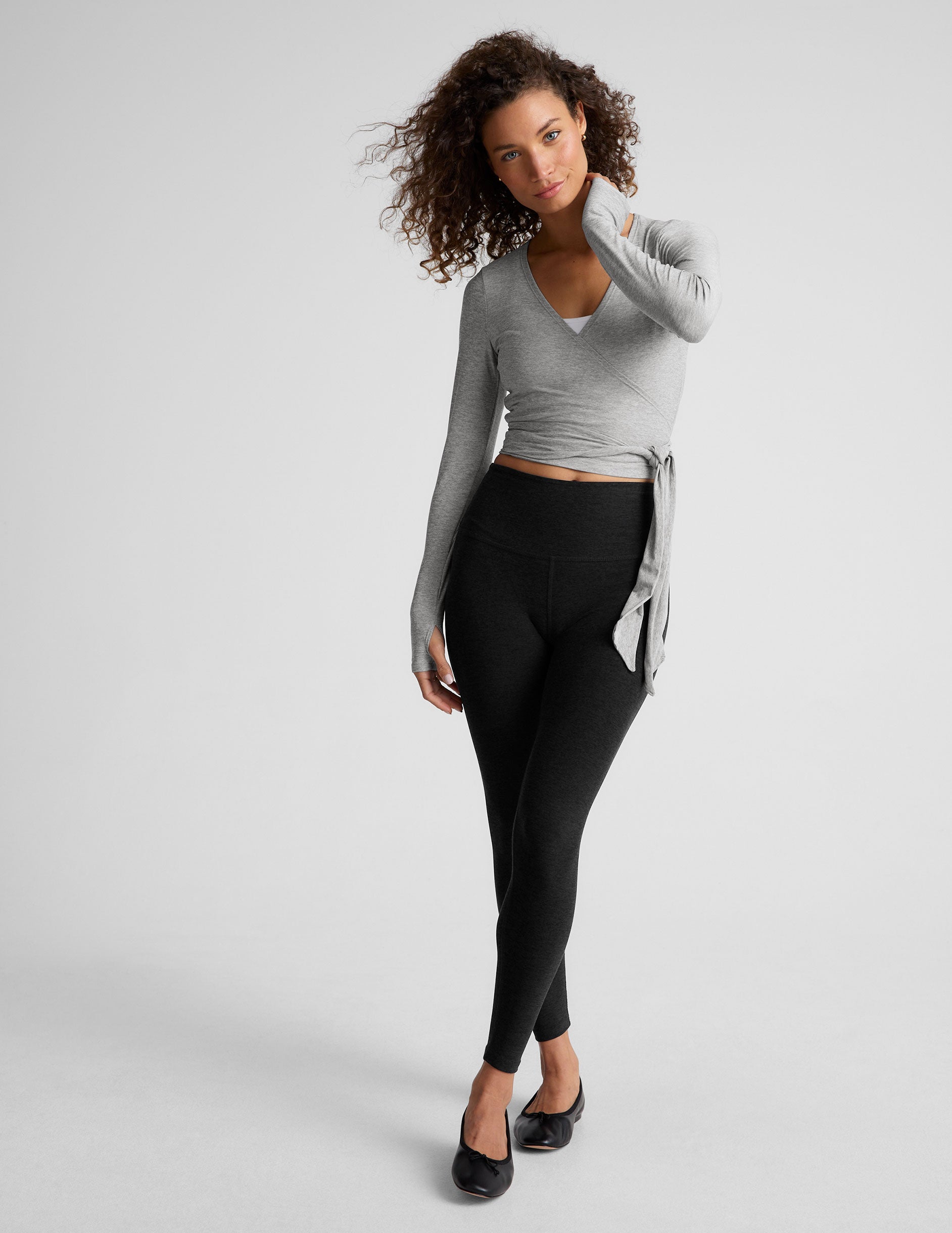 gray long sleeve wrap top with thumb holes. 