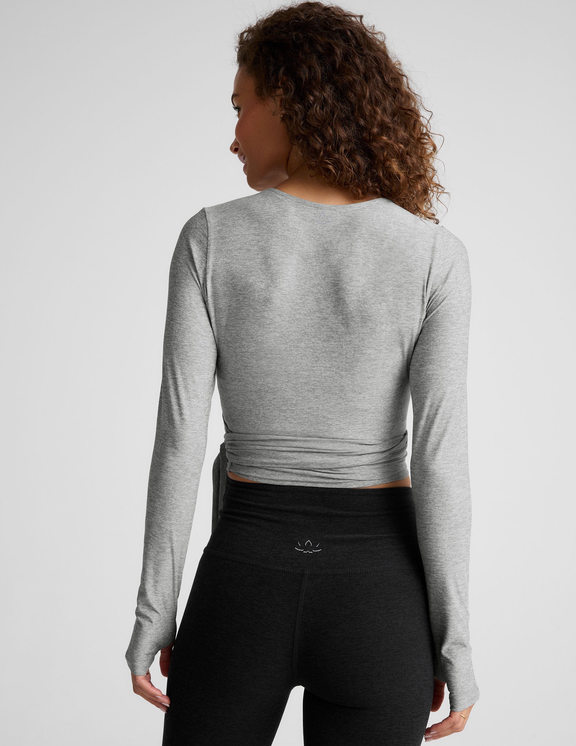 gray long sleeve wrap top with thumb holes. 