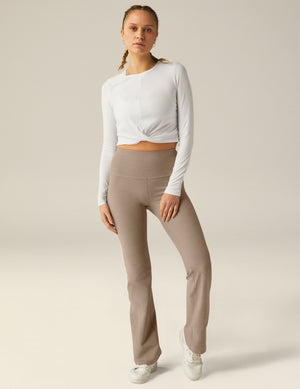 white scoop neck featherweight long sleeve cropped top with a front crossover detail. 