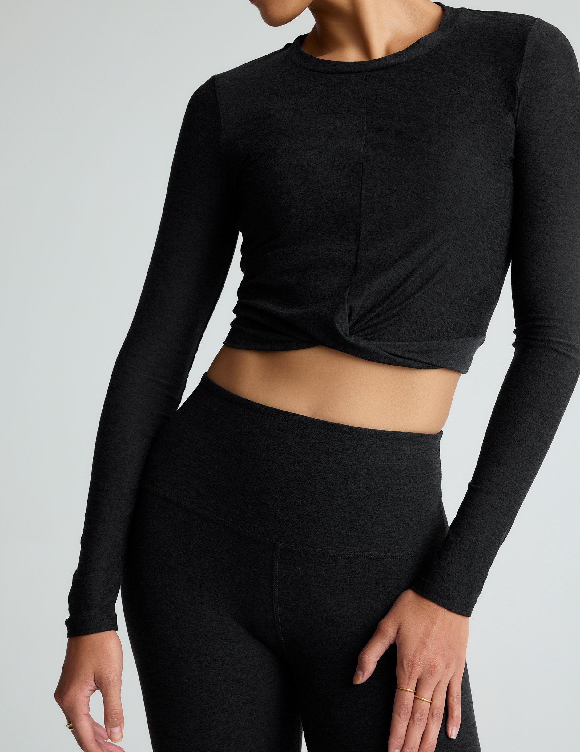 black scoop neck featherweight long sleeve cropped top with a front crossover detail.