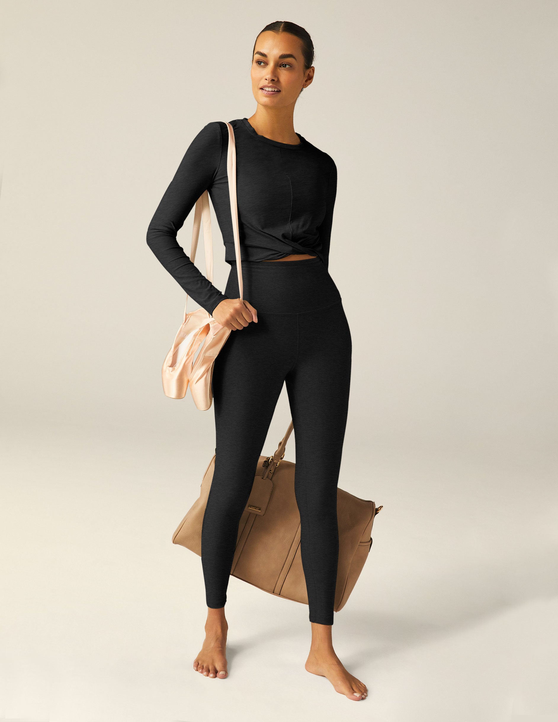 black scoop neck featherweight long sleeve cropped top with a front crossover detail.