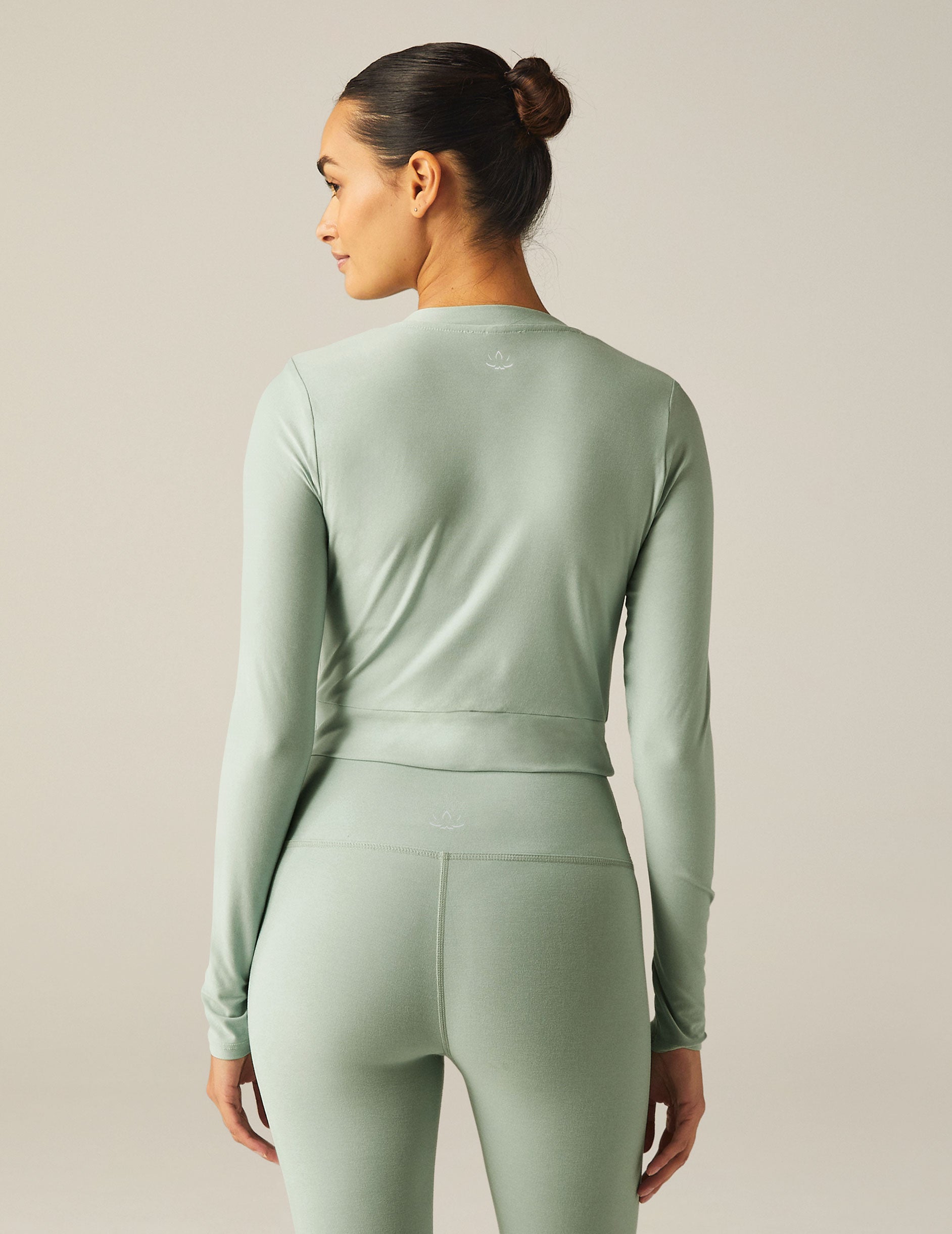 featherweight cropped fitted long sleeve top with a front crossover detail. 