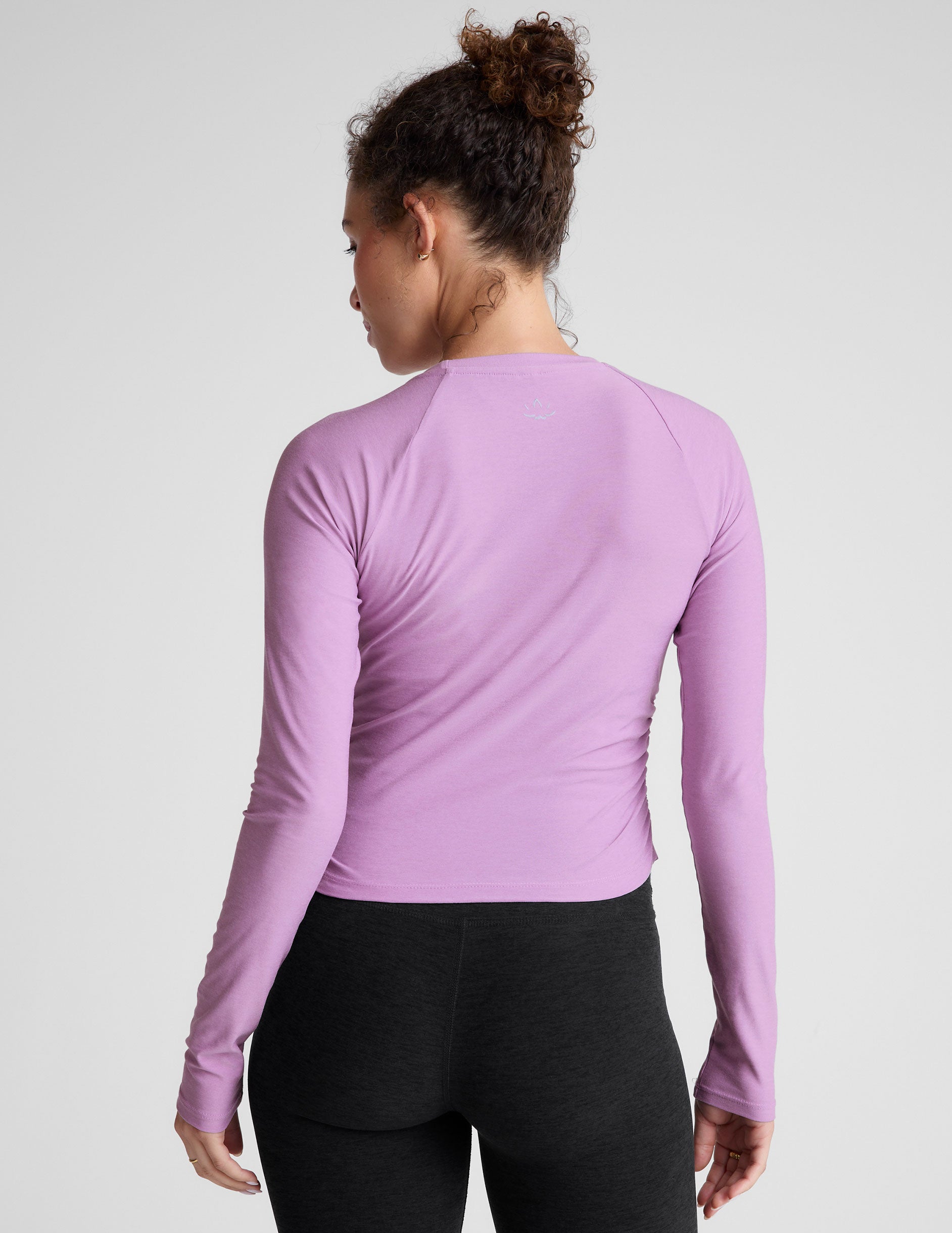 purple scoop neck long sleeve top with shirring on the sides. 