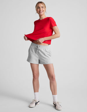 red cropped loose-fitting t-shirt with a scooped neckline. 