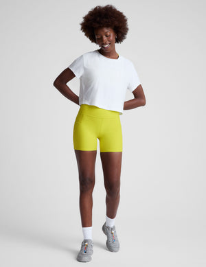 white lightweight loose-fitting cropped tee with a scoop neckline.  