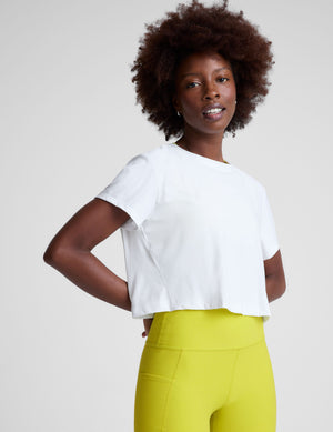 white lightweight loose-fitting cropped tee with a scoop neckline.  