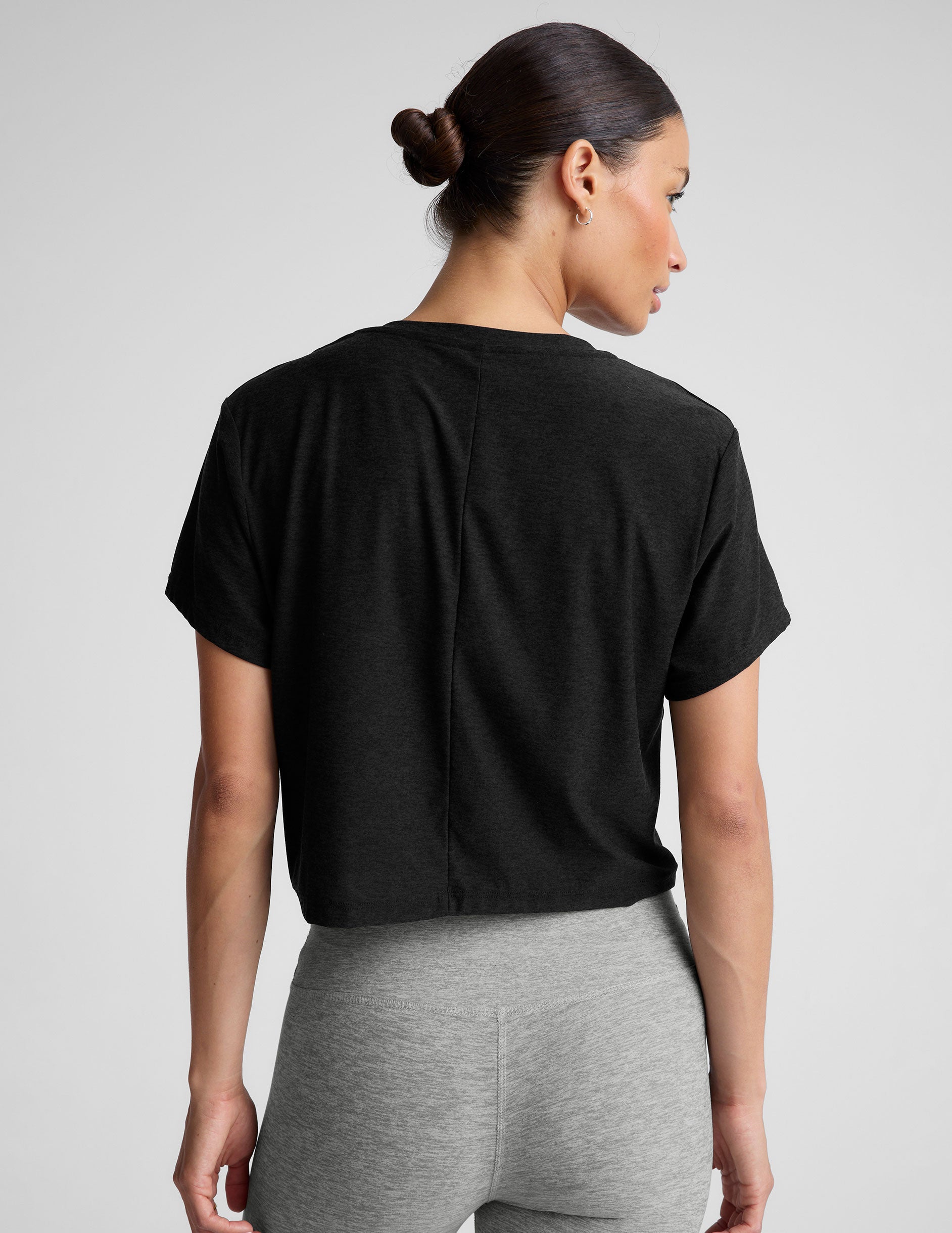 black relaxed fit cropped tee with a scoop neckline. 