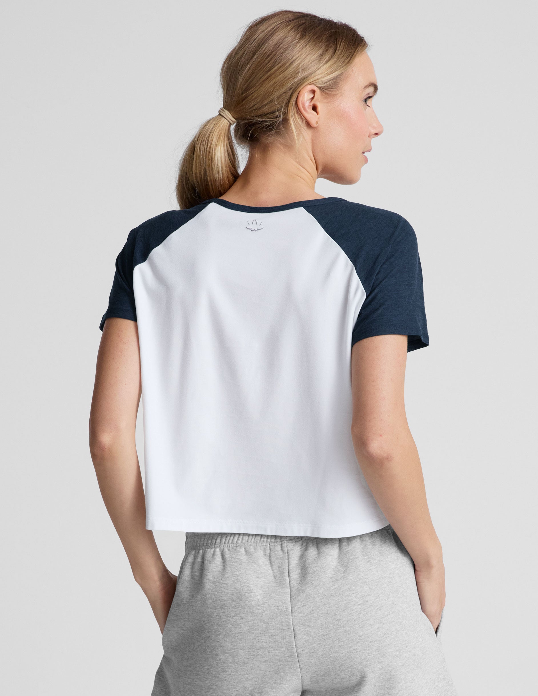 white relaxed fit, waist length t-shirt with colorblock raglan sleeve and neck binding. 