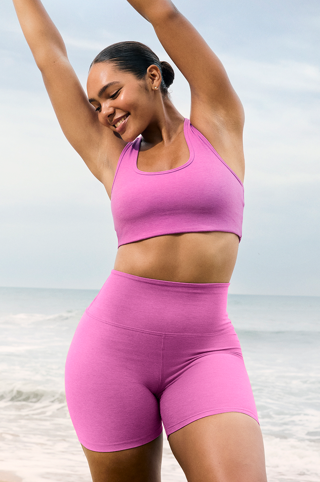 pink bra with pink high-waisted biker shorts. 