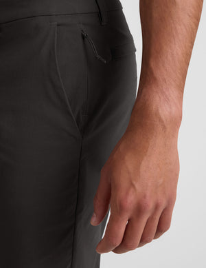 Person wearing dark gray pants and a gray shirt on a white background. 