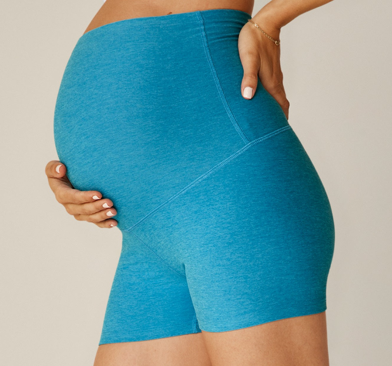 model is wearing blue maternity biker shorts with a 3" inseam. 