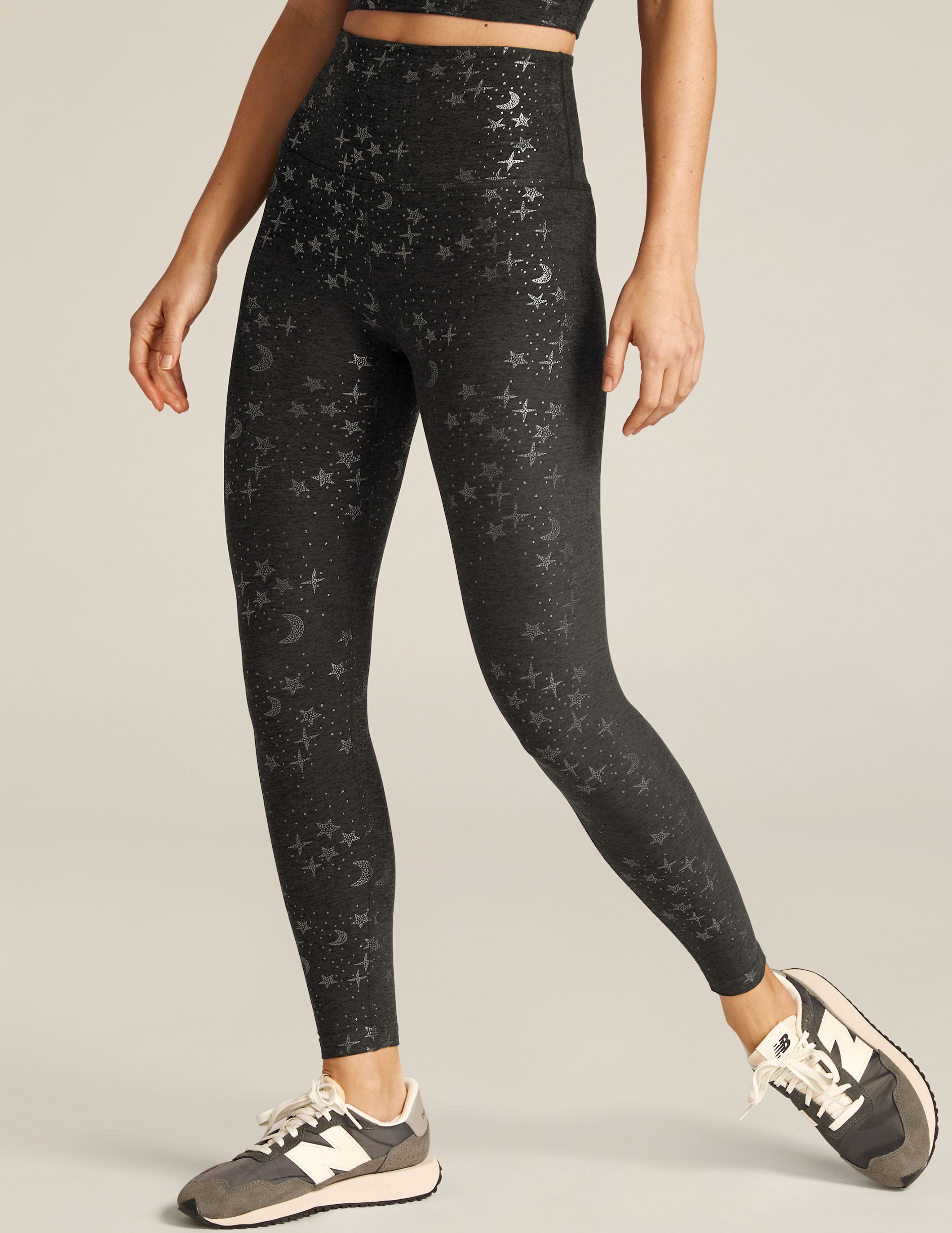 black high-waisted midi legging with silver stars. 