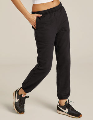 Black mid-rise On the Go Jogger with a relaxed fit, elastic waistband, and cinched cuffs, shown on a model mid-stride.