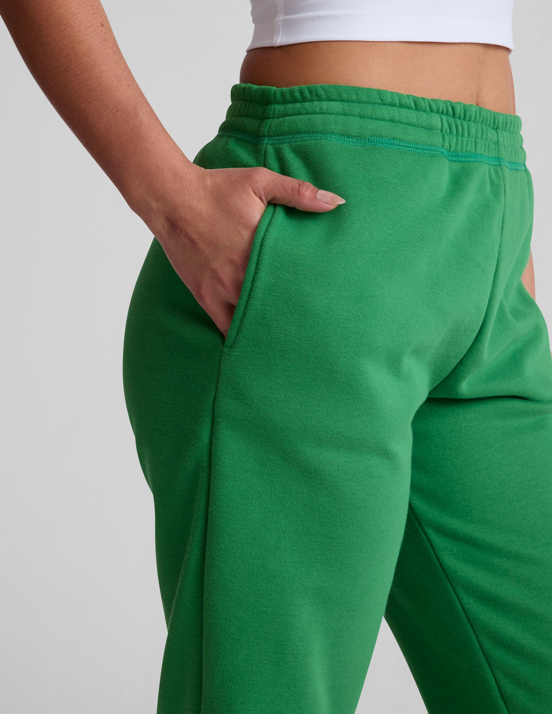 green midi length joggers with pockets. 