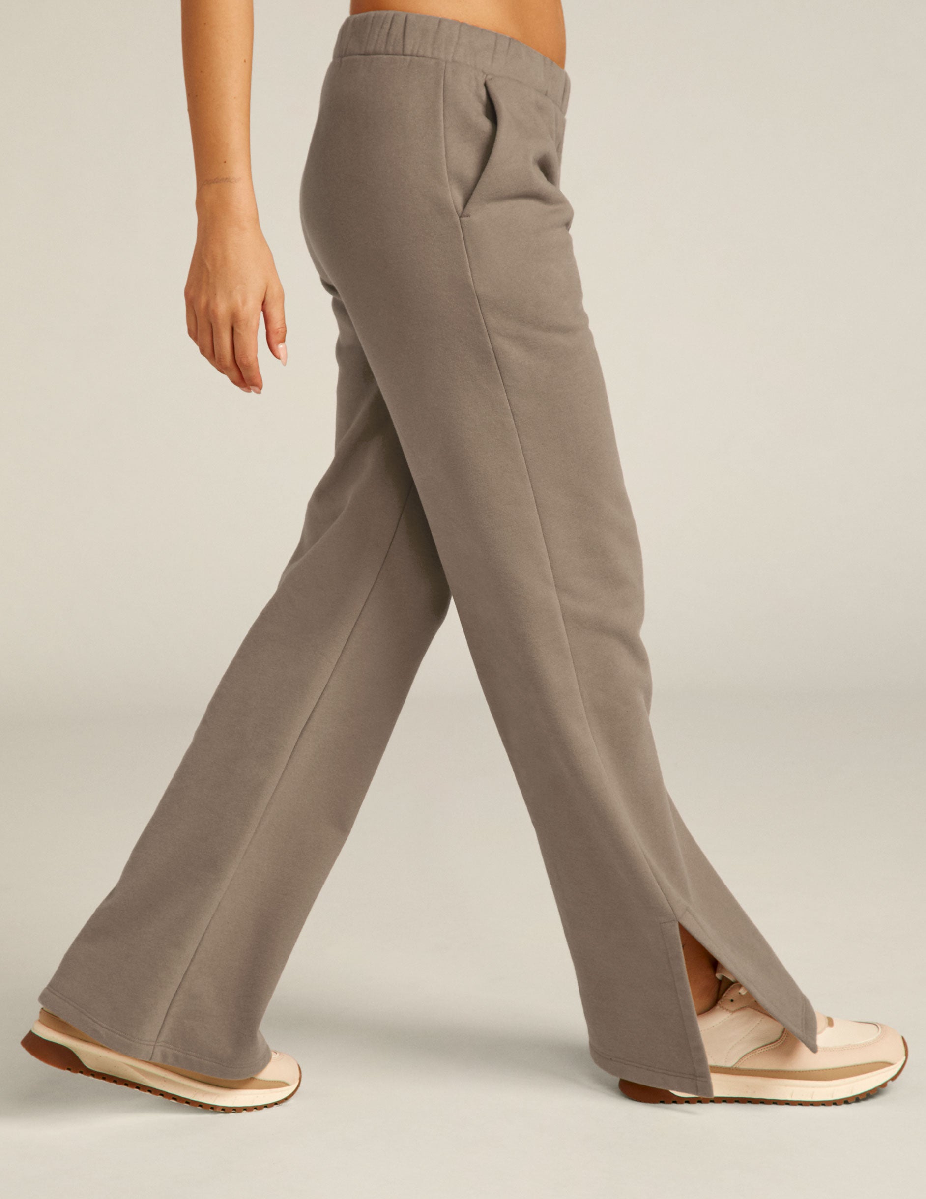 brown high rise pants with pockets and slit hem. 
