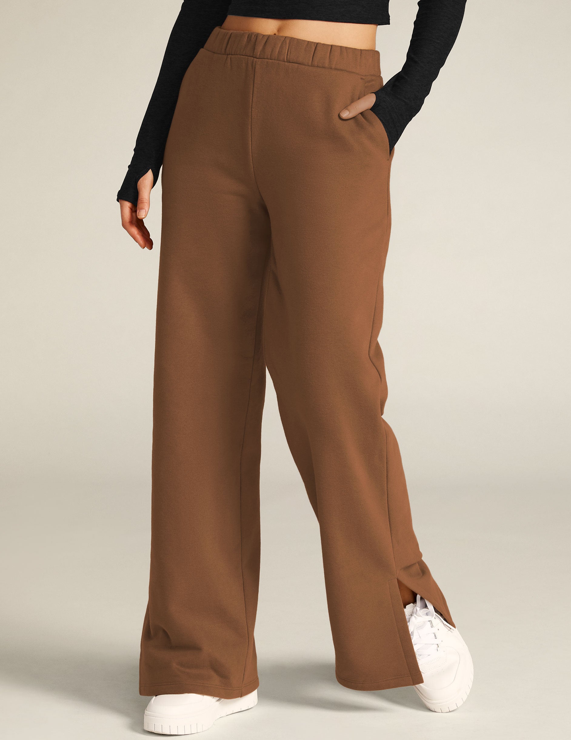 brown pants with side slits by the ankle. 