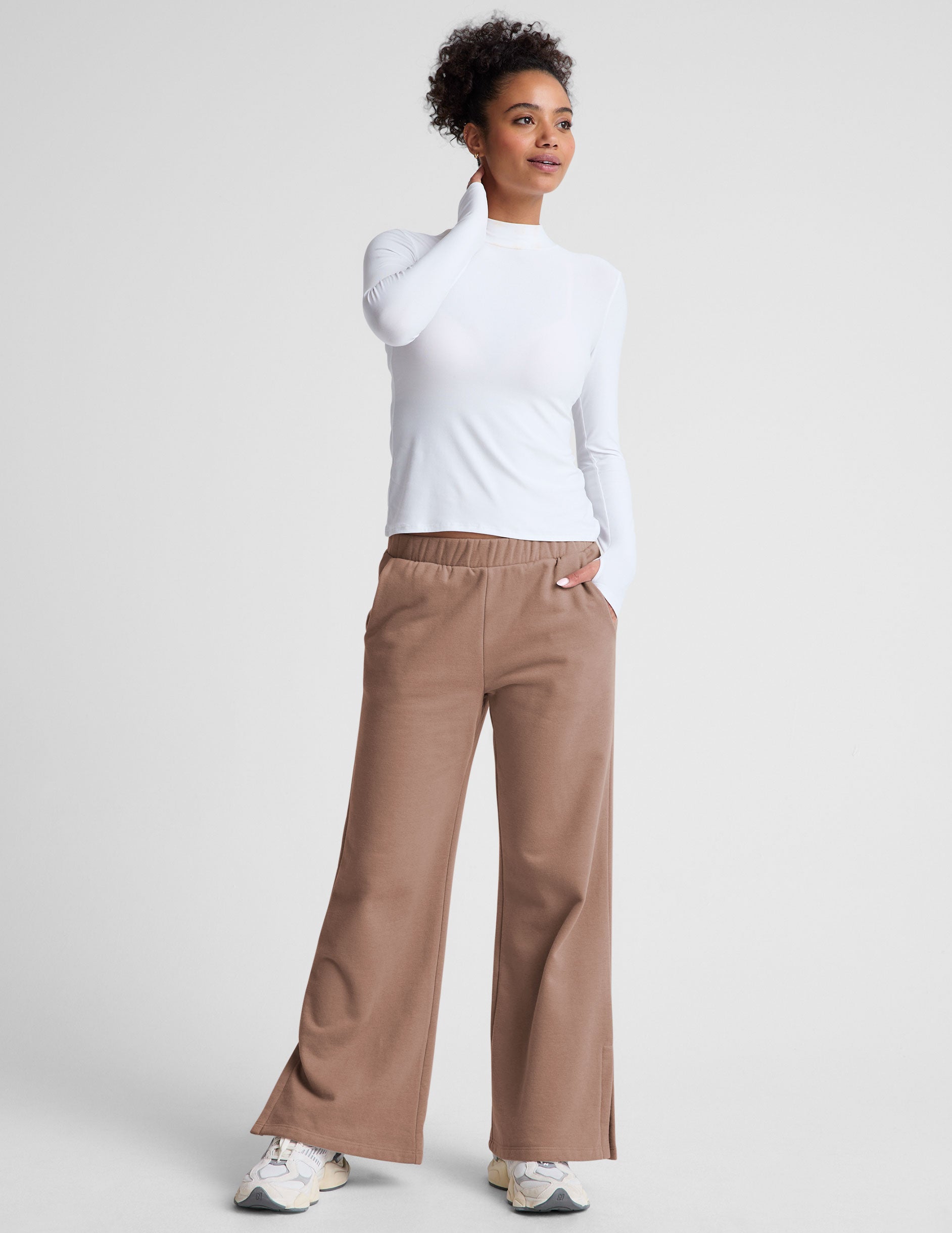 brown wide leg sweatpants with pockets and side slits by ankle. 