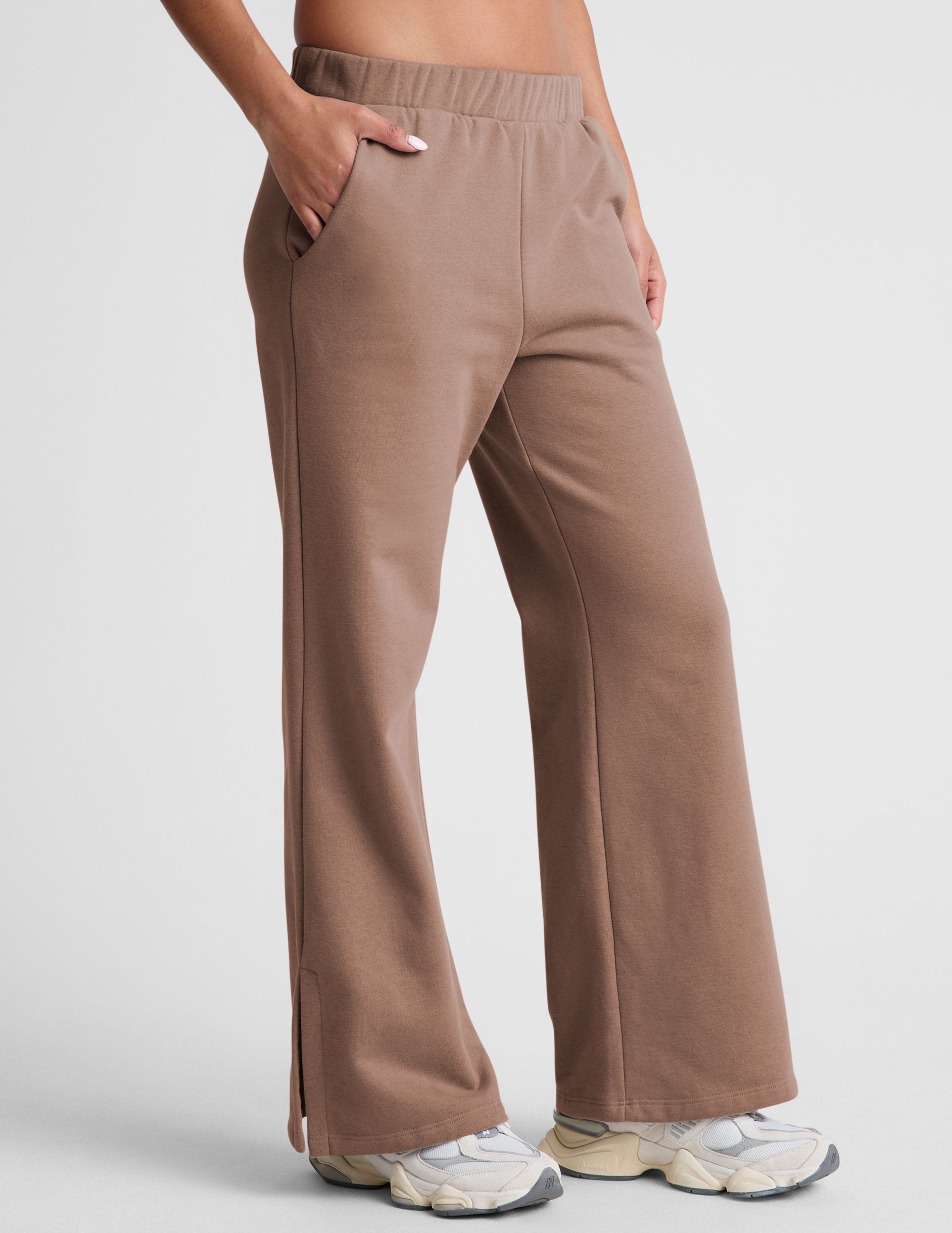 brown wide leg sweatpants with pockets and side slits by ankle. 