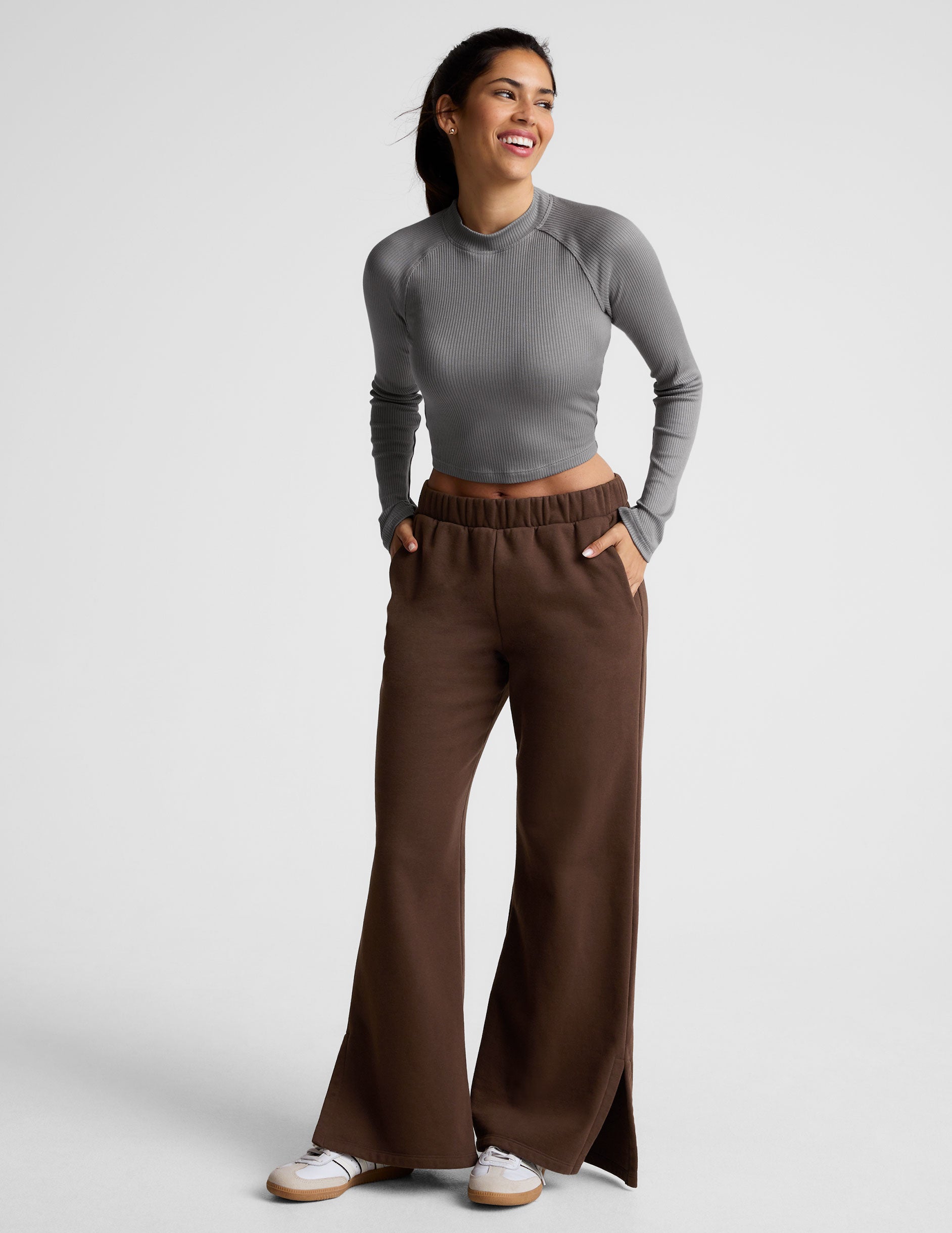 brown mid-rise, wide leg fleece sweatpants with side slits at the ankle and pockets. 